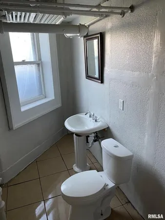a white toilet sitting next to a bathroom sink
