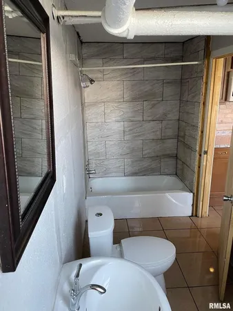a bathroom with a bathtub and shower