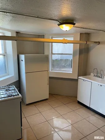 a kitchen with a stove and a refrigerator