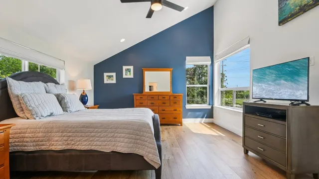 a bedroom with a bed and wooden floor