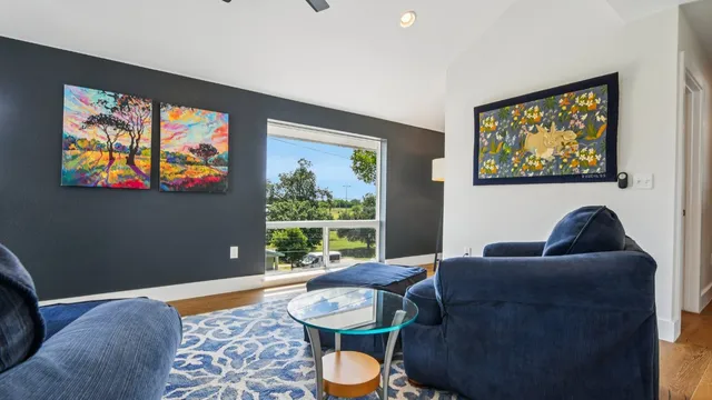 a living room with furniture and a painting on the wall