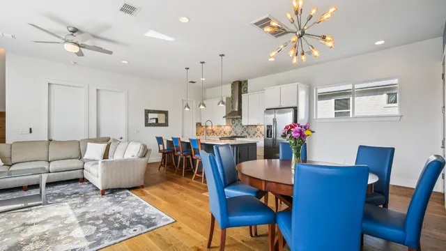 a living room with dining room and wooden floor