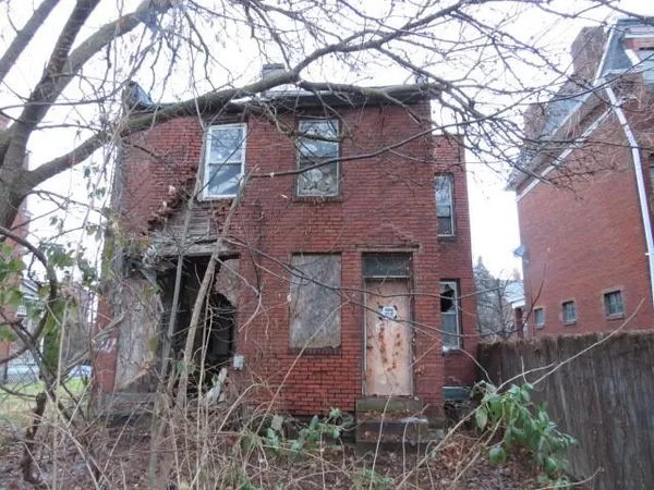 a view of a brick house with a yard