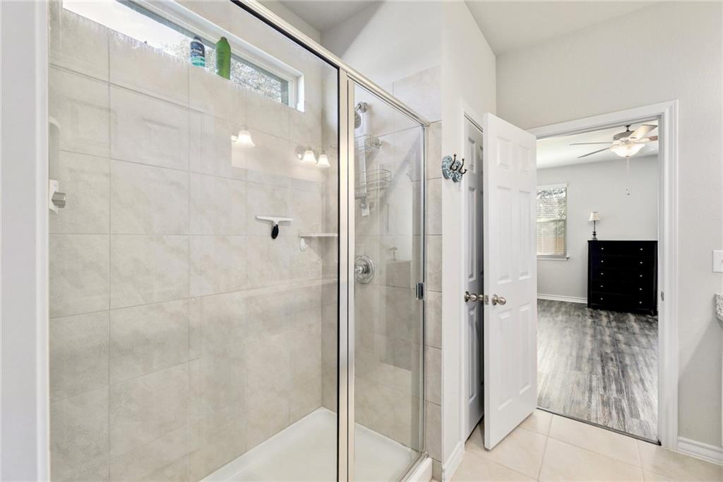 204 Tulum Terrace Leander, TX 78641 - Photo 6 of 22 Bathroom featuring a stall shower, tile patterned floors, and ceiling fan