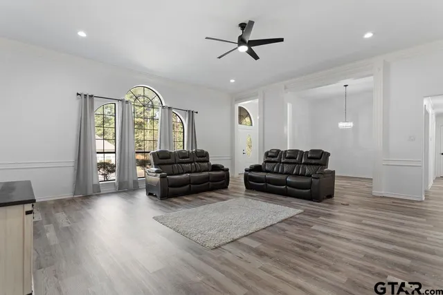 a living room with furniture and a wooden floor