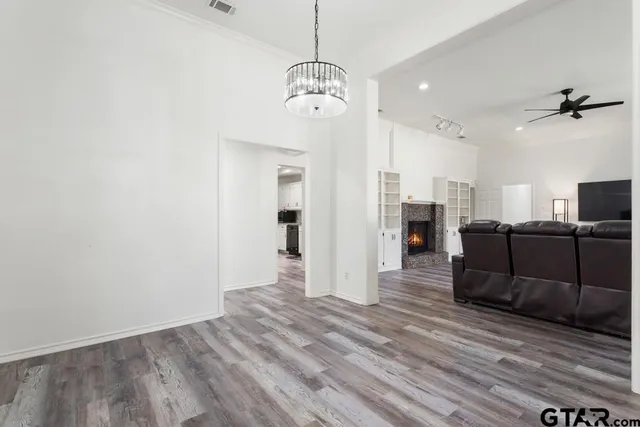 a view of a room with wooden floor and windows