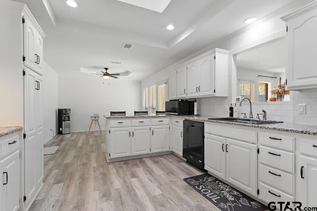 a kitchen with sink cabinets and refrigerator