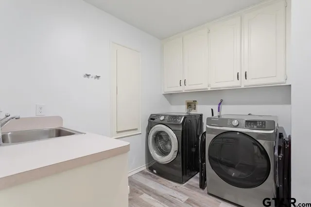 a utility room with sink dryer and washer