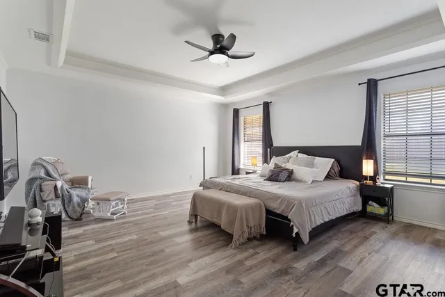 a bedroom with a bed and wooden floor