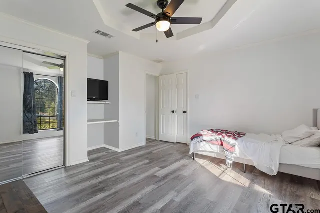 a bedroom with a bed and a chandelier