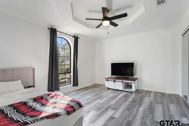 a bedroom with a bed and a flat screen tv