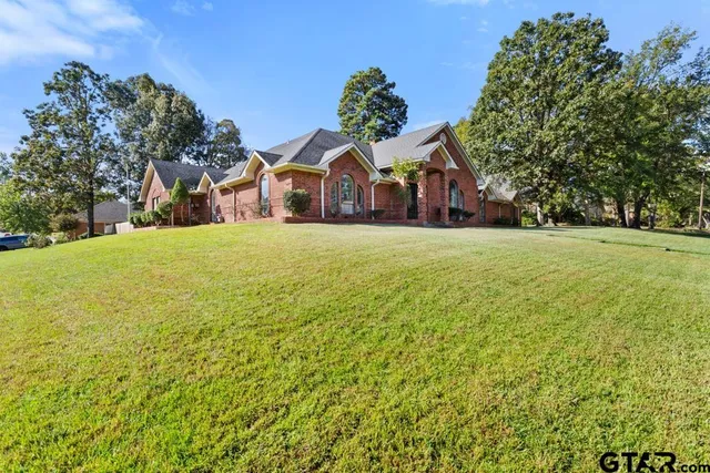 a front view of a house with a big yard