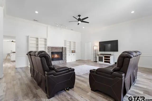 a living room with furniture a fireplace and a flat screen tv