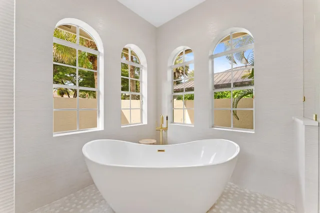 a large bedroom with a large bed and a large window