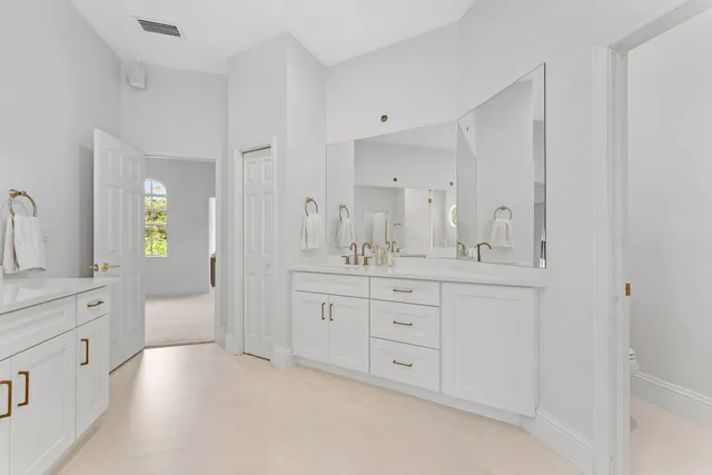 a large bed sitting in a room next to a window