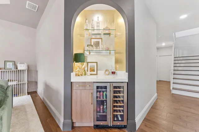a large dining space with furniture a chandelier and wooden floor