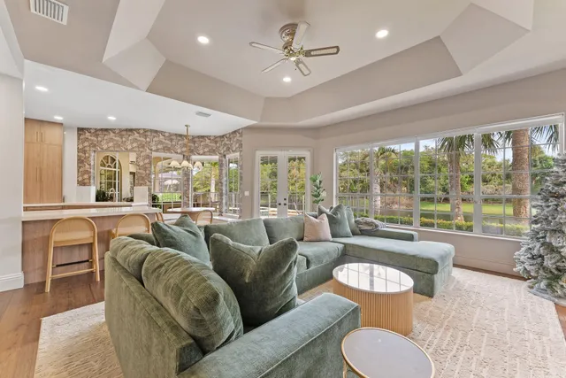 a view of a dining room with furniture and chandelier