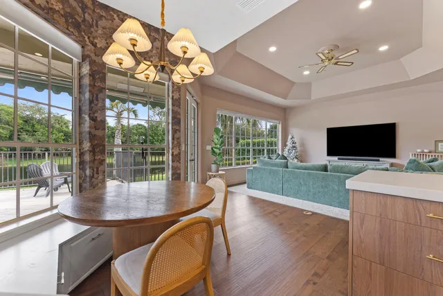a view of a swimming pool with a patio and a yard