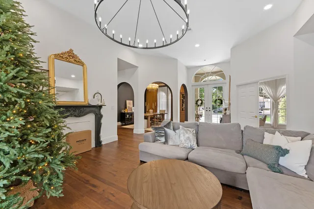 an aerial view of residential houses with outdoor space and trees