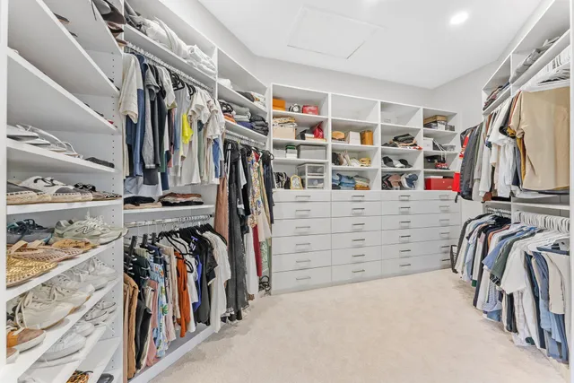 a spacious bathroom with a granite countertop sink mirror and bathtub