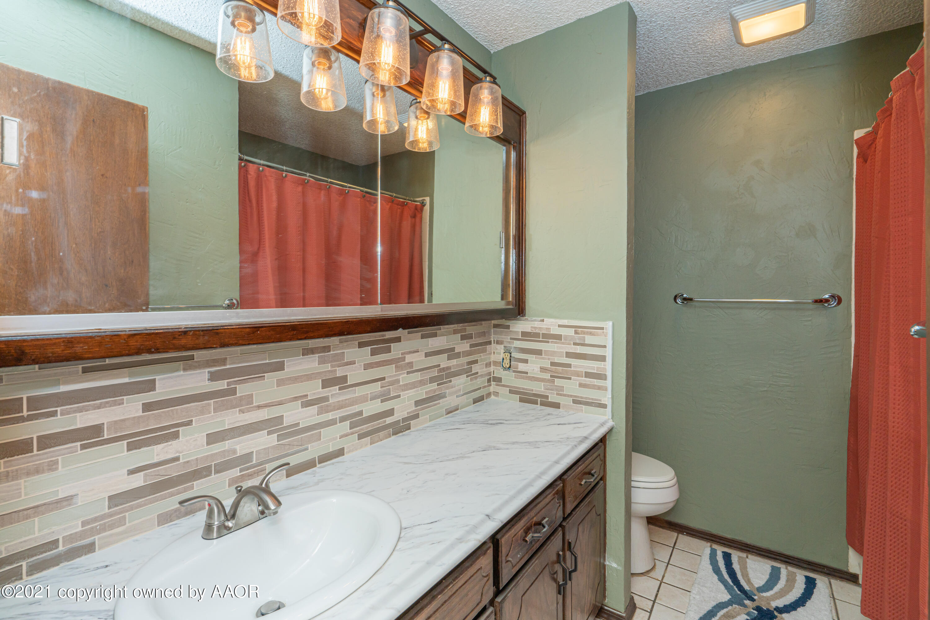 5811 Hardwick Drive Amarillo, TX 79109 - Photo 14 of 24 a bathroom with a sink and a mirror