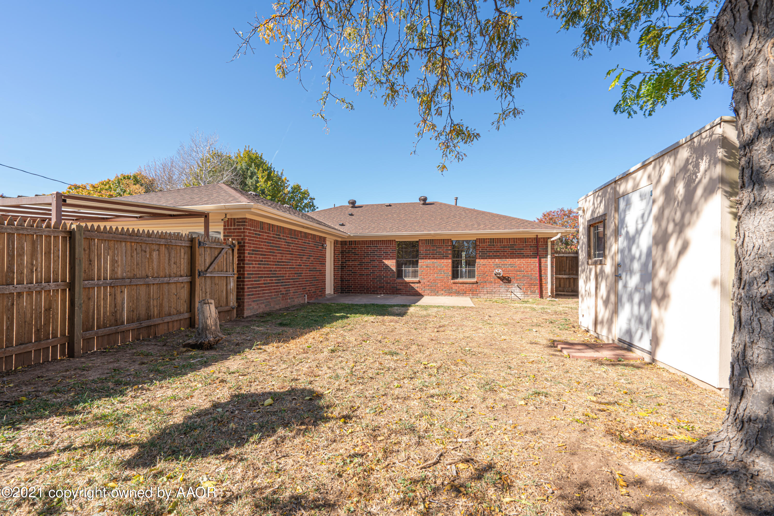 5811 Hardwick Drive Amarillo, TX 79109 - Photo 21 of 24 a front view of a house with a yard and garage