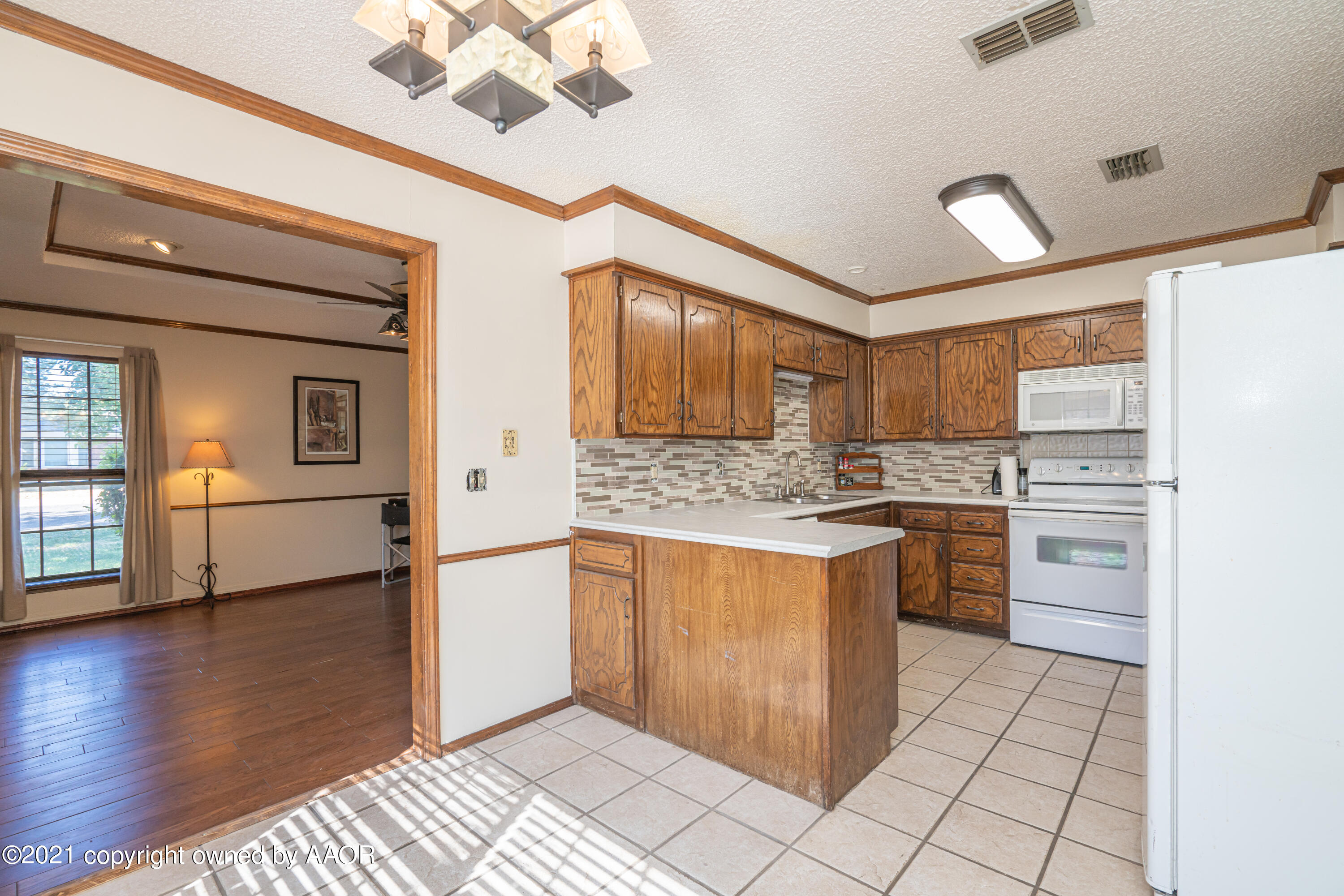 5811 Hardwick Drive Amarillo, TX 79109 - Photo 6 of 24 a kitchen with stainless steel appliances granite countertop a refrigerator and a sink