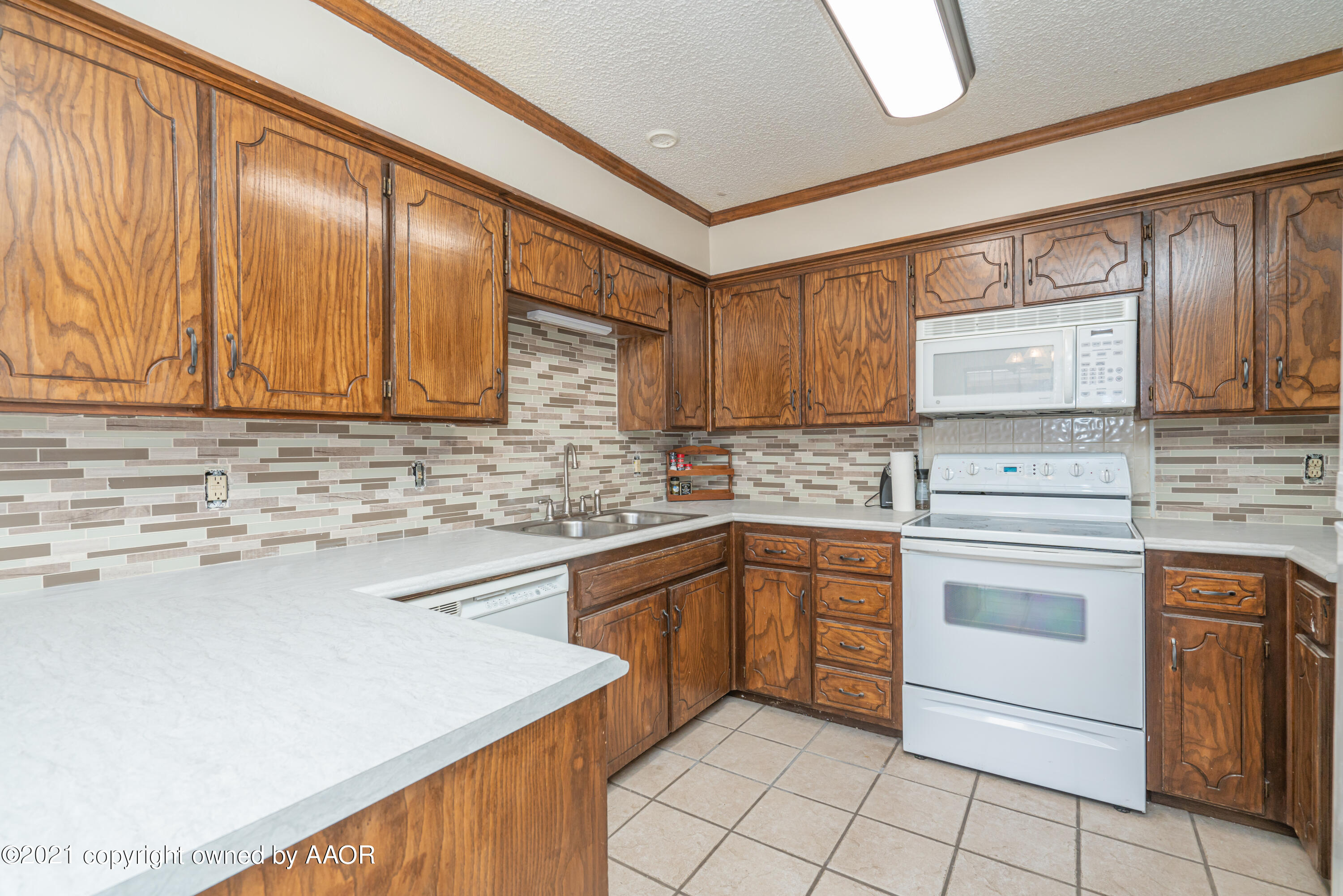 5811 Hardwick Drive Amarillo, TX 79109 - Photo 8 of 24 a kitchen with cabinets appliances and a sink