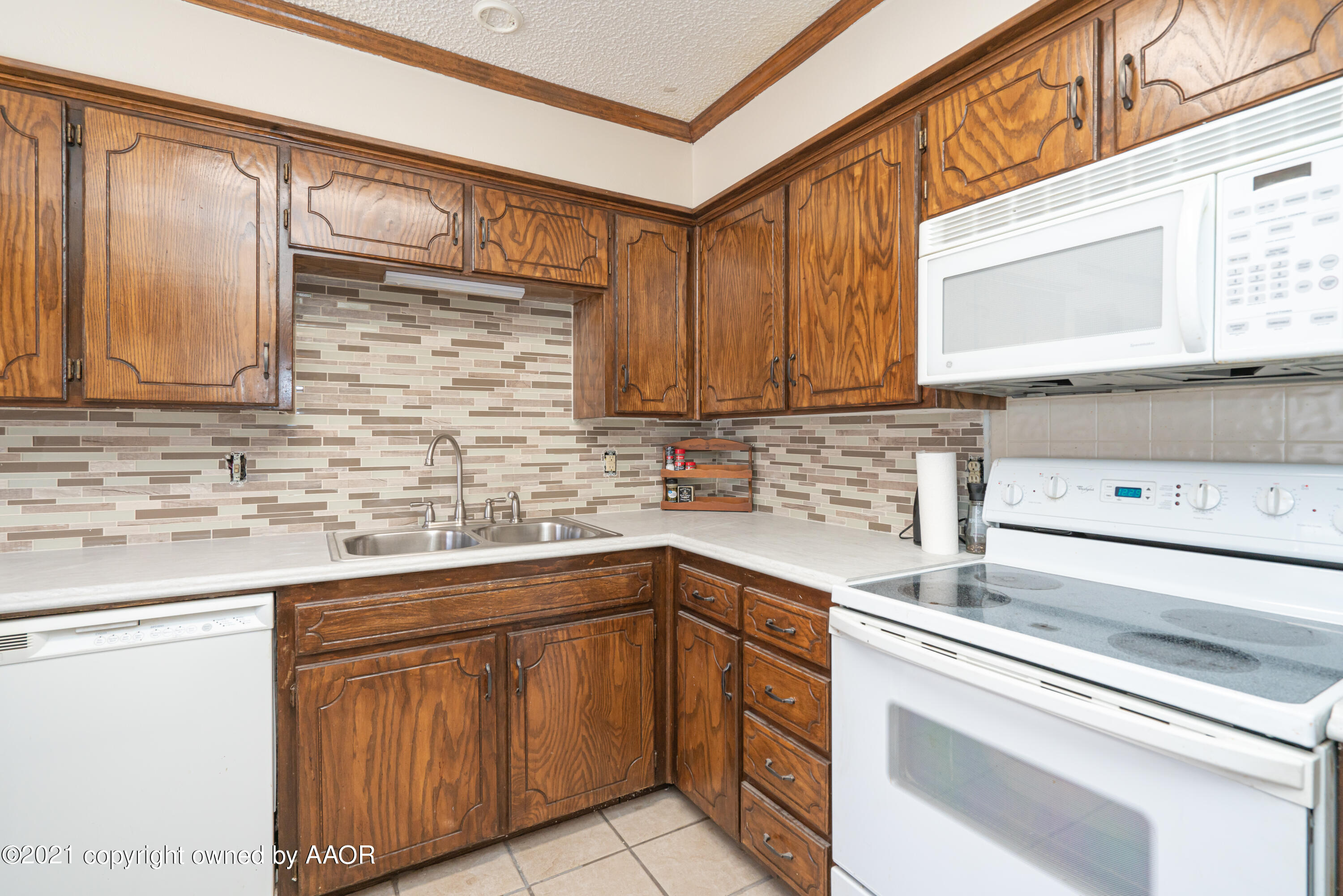 5811 Hardwick Drive Amarillo, TX 79109 - Photo 9 of 24 a kitchen with stainless steel appliances granite countertop a sink and cabinets