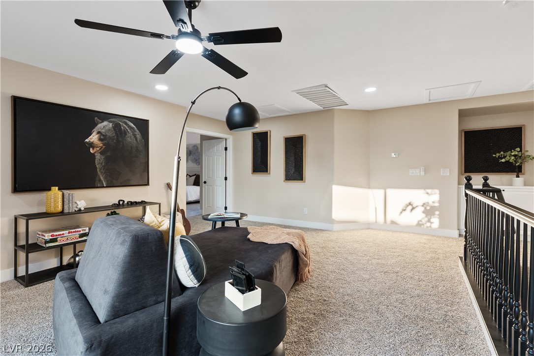 1662 Ravanusa Drive Henderson, NV 89052 - Photo 40 of 74 A spacious, naturally illuminated loft provides an inviting retreat, complete with a contemporary ceiling fan and plush carpeting.