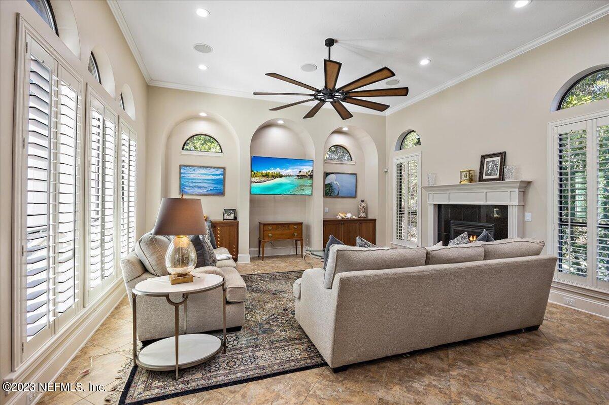 142 Marshall Creek Drive St. Augustine, FL 32095 - Photo 13 of 61 a living room with furniture a fireplace and a large window