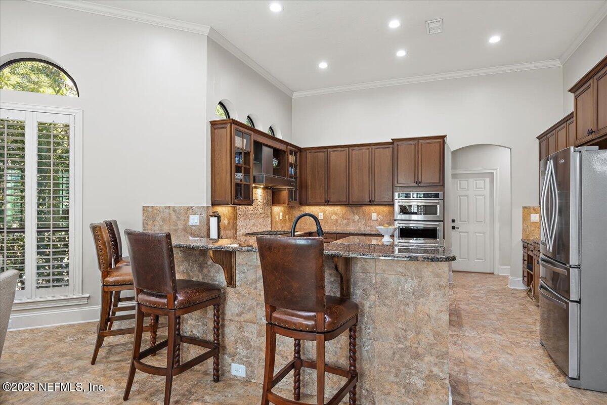 142 Marshall Creek Drive St. Augustine, FL 32095 - Photo 15 of 61 a kitchen with kitchen island a large window appliances and furniture