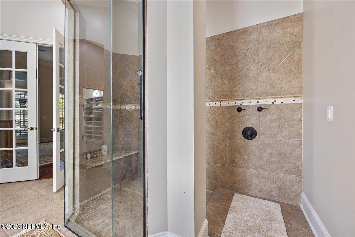 142 Marshall Creek Drive St. Augustine, FL 32095 - Photo 22 of 61 a bathroom with a glass shower door