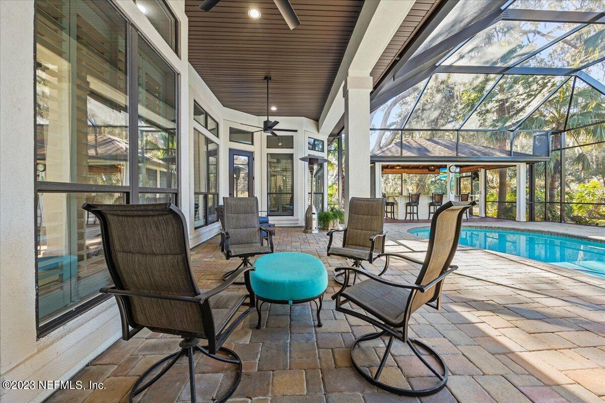 142 Marshall Creek Drive St. Augustine, FL 32095 - Photo 26 of 61 a living room with furniture and a floor to ceiling window
