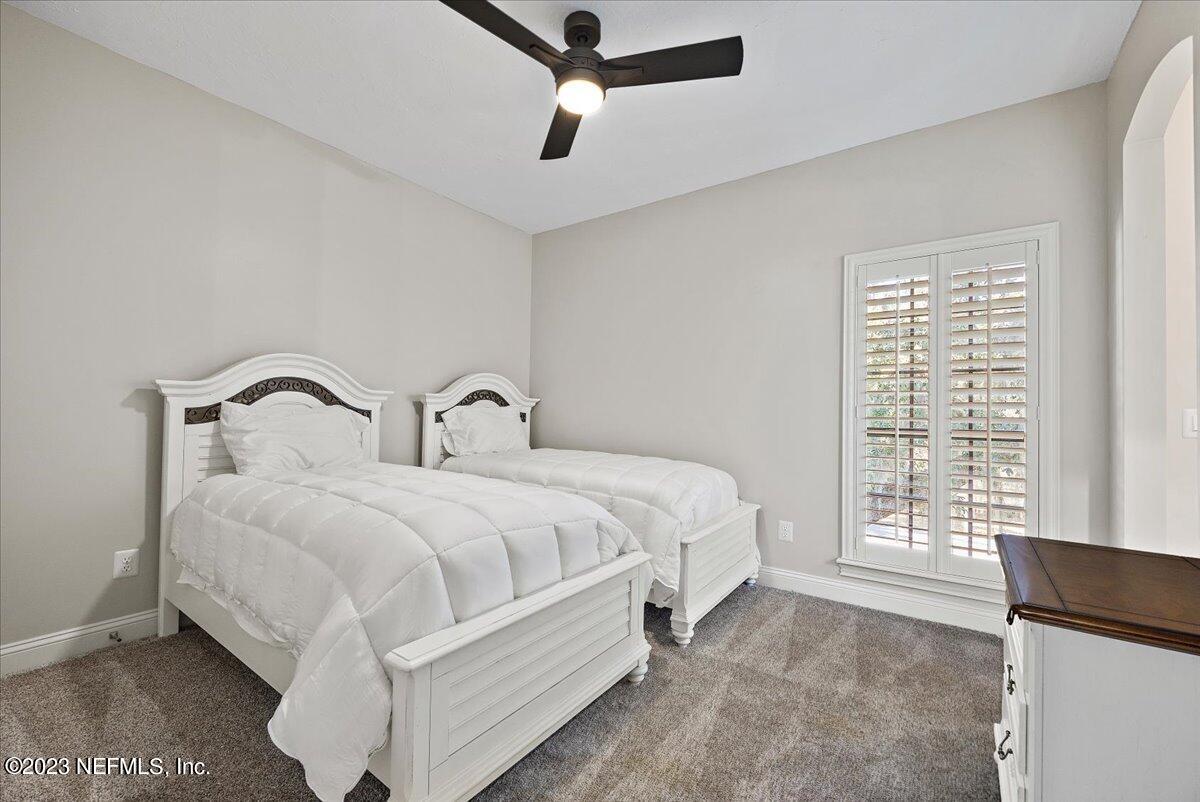 142 Marshall Creek Drive St. Augustine, FL 32095 - Photo 37 of 61 a bed sitting in a bedroom next to a window