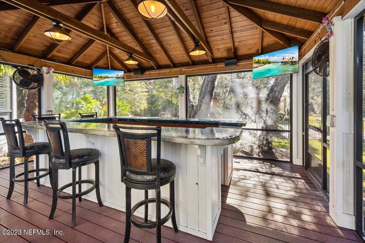 142 Marshall Creek Drive St. Augustine, FL 32095 - Photo 4 of 61 a patio with wooden floor a yard table and chairs