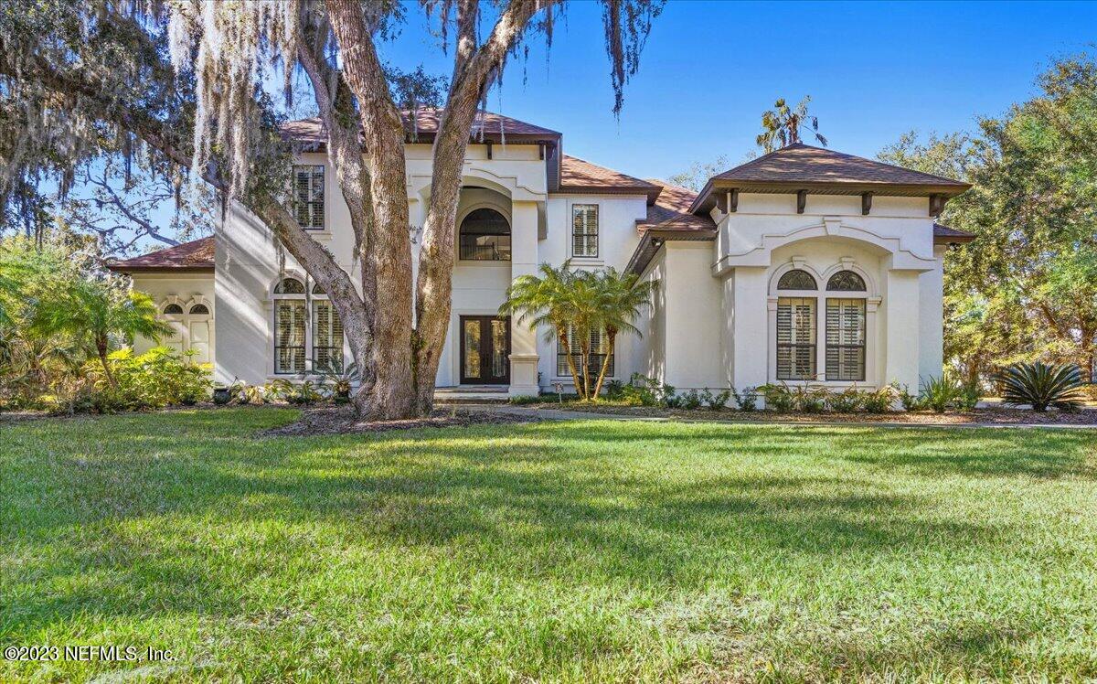 142 Marshall Creek Drive St. Augustine, FL 32095 - Photo 52 of 61 a front view of a house with a garden