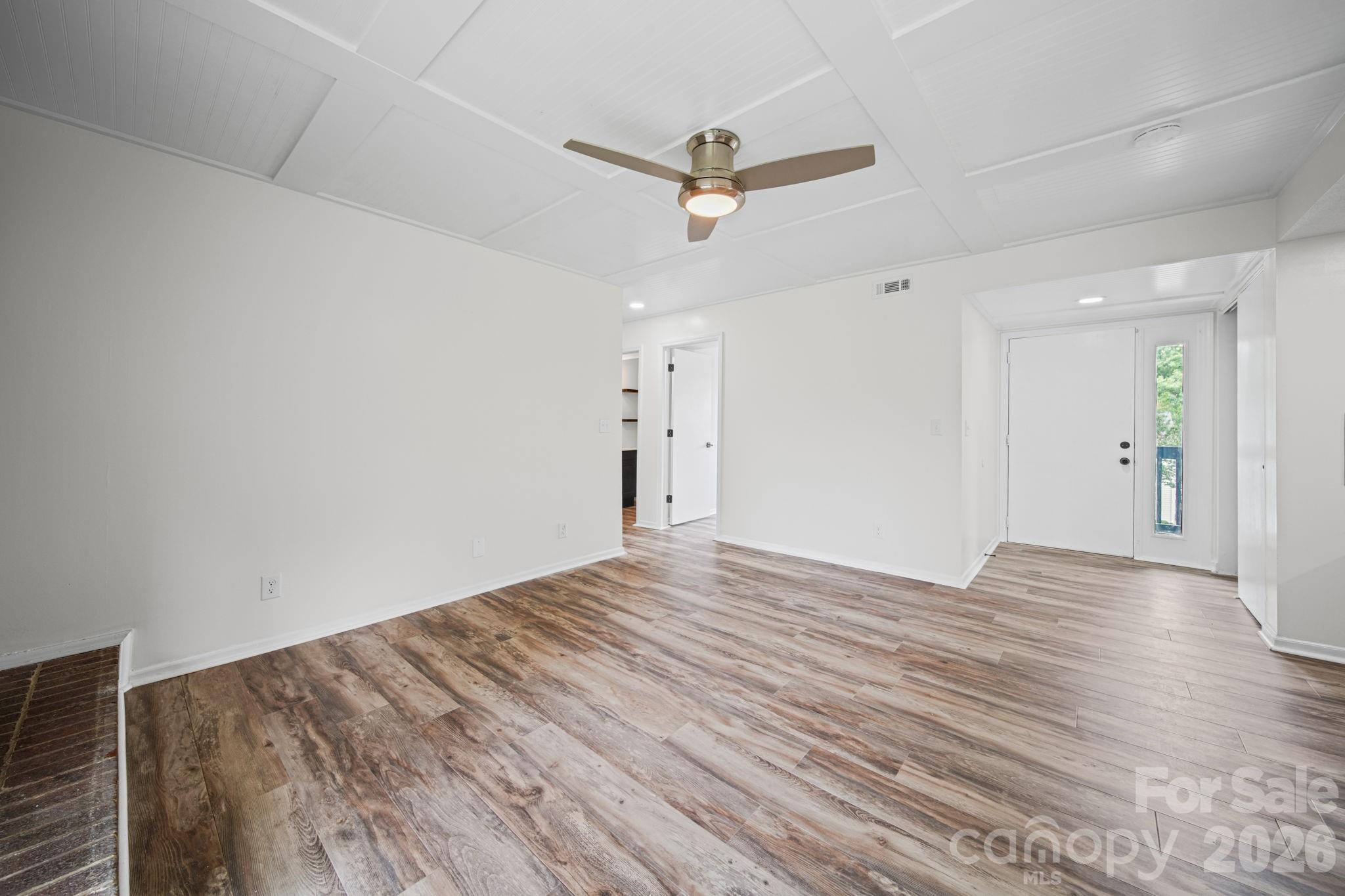 11023 Harrowfield Road Charlotte, NC 28226 - Photo 5 of 32 a view of empty room with wooden floor and ceiling fan