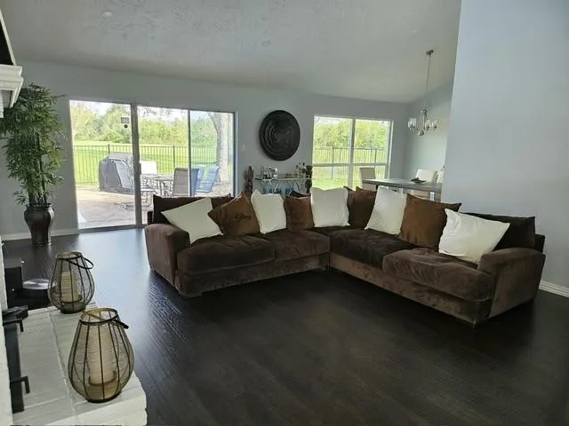 a living room with furniture and a floor to ceiling window