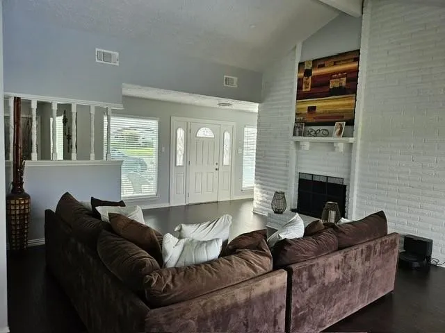 a living room with furniture and a fireplace