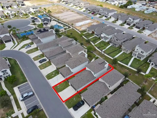 an aerial view of a houses with a city view