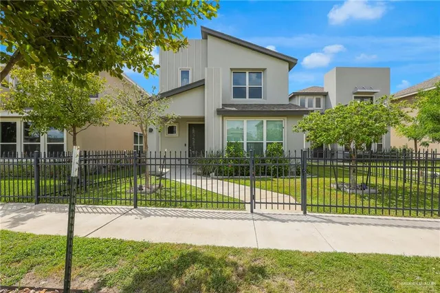 a view of a house with a backyard and a garden