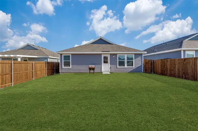 a front view of a house with a garden and yard