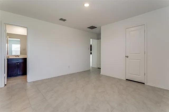 a view of an empty room and a bathroom