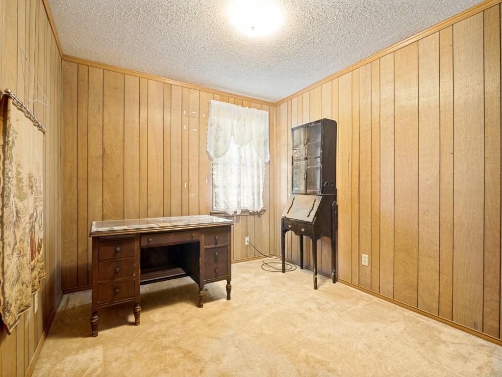 1081 Wright Street Terrell, TX 75160 - Photo 21 of 29 Room featuring wood paneling walls and a textured ceiling