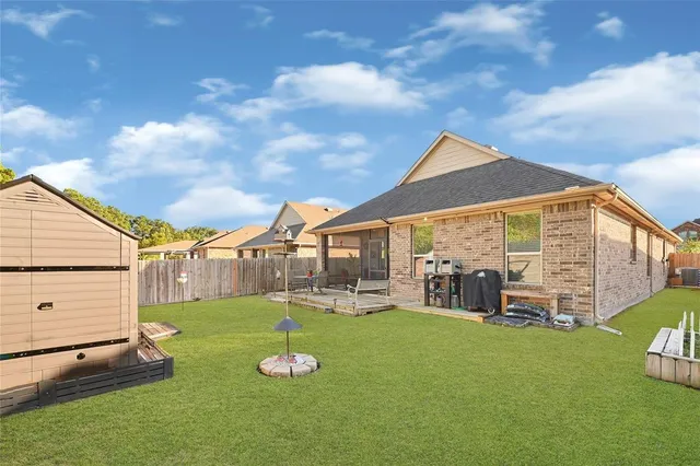 a view of yard with swimming pool and green space