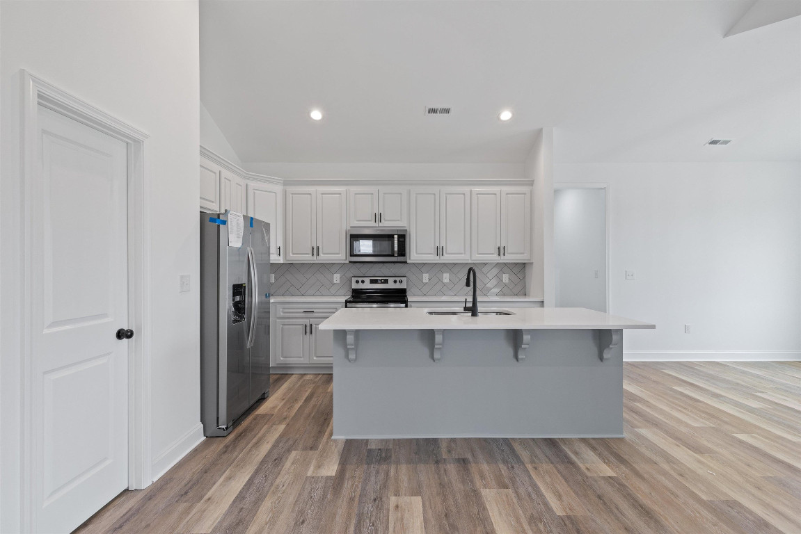 4000 Origin Drive Bailey, NC 27807 - Photo 12 of 47 a large kitchen with stainless steel appliances a sink and wooden floor
