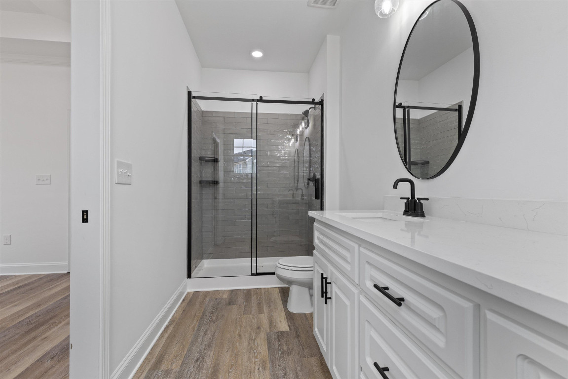 4000 Origin Drive Bailey, NC 27807 - Photo 31 of 47 a bathroom with a sink a mirror a vanity and glass door shower