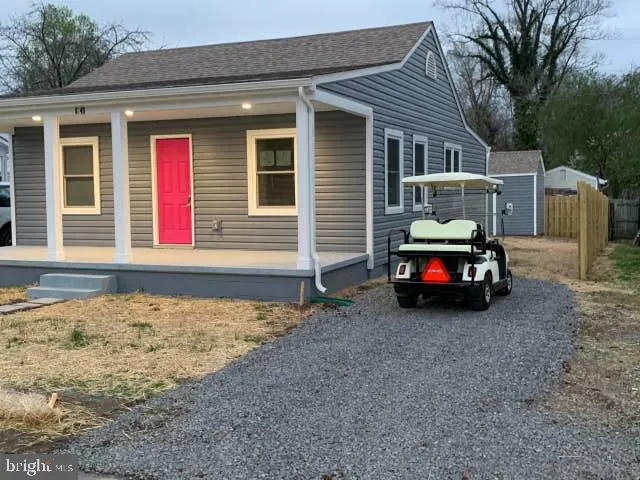a car parked in front of white house