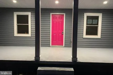 a street sign on a wall next to a road